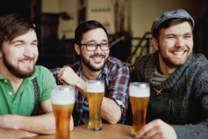 Three men having a good time while drinking beer